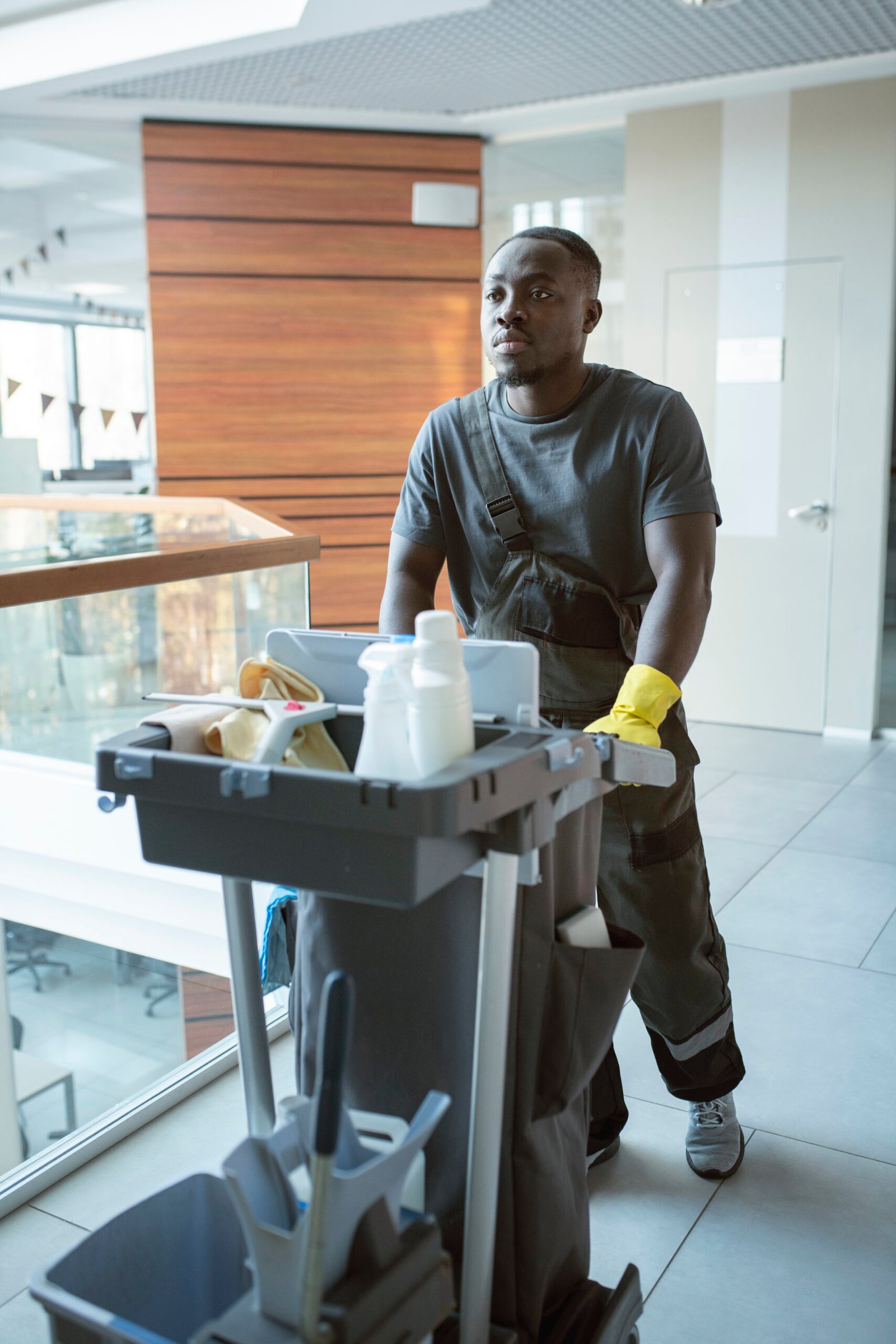 man-walking-with-cleaning-cart-full-shot